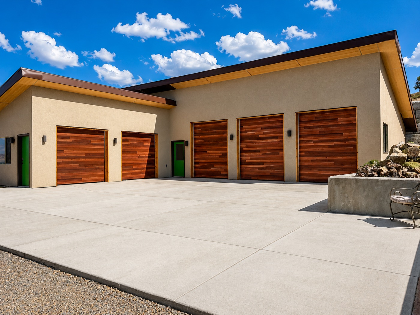 Three matched wood-tone custom sectional garage doors on a contemporary Western Slope home