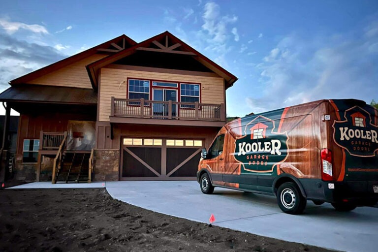custom wood garage door installation with the Kooler van parked in front