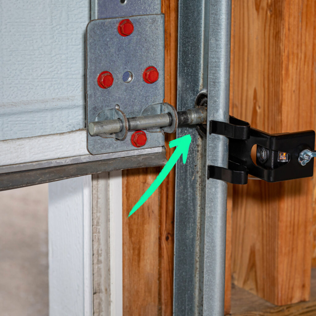 stock image with green arrow pointing at a garage door roller