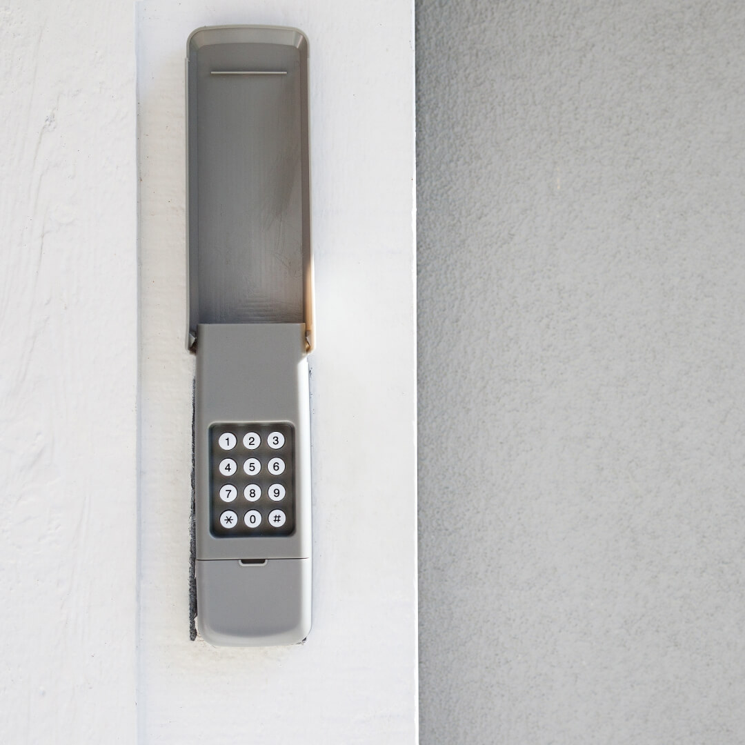 Garage door keypad stock image on a white trim garage